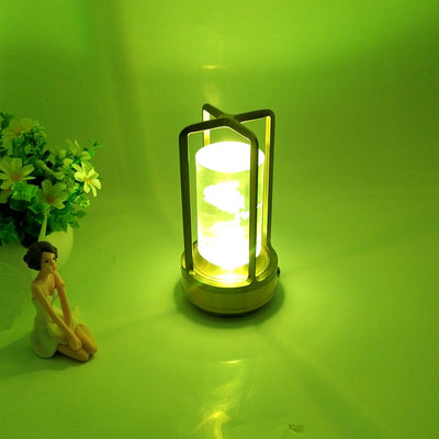 USB charging retro camping light in gold, emitting a soft green glow, surrounded by decorative flowers.